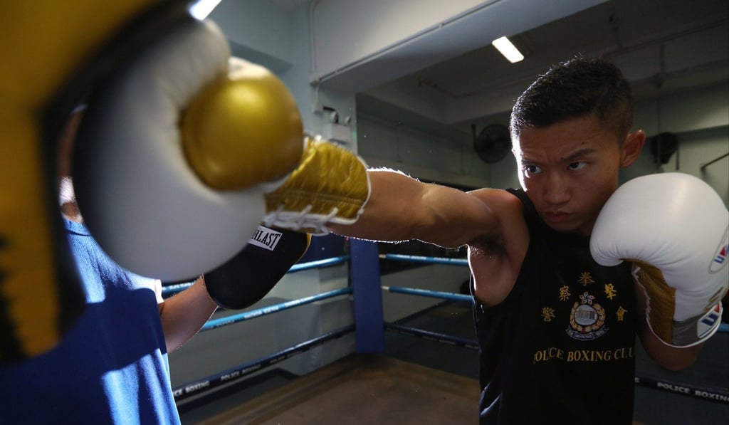 Edwin Ng hits pads in front of Operation Breakthrough recruits at Tai Po Police Station. Photo: Felix Wong