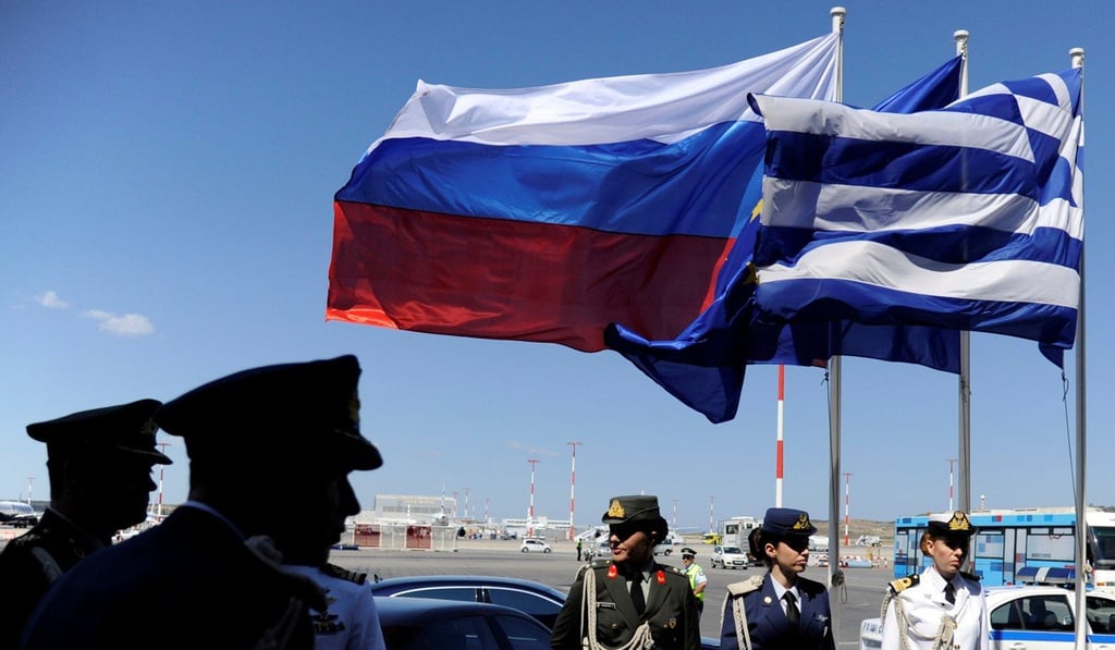 Greek police and army officers stand by Greek, Russian and EU flags as they wait for the arrival of Russian President Vladimir Putin in Athens in 2016. Photo: Reuters