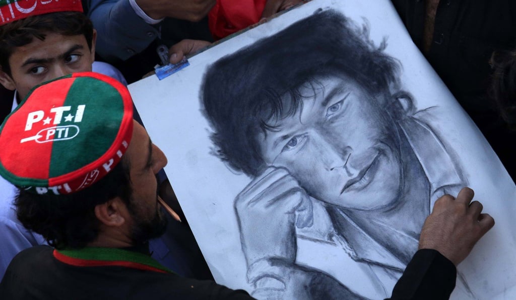 A supporter of political party Pakistan Tehrik-e-Insaf, draws a sketch of Imran Khan. Photo: EPA A supporter of political party Pakistan Tehrik-e-Insaf, draws a sketch of Imran Khan. Photo: EPA
