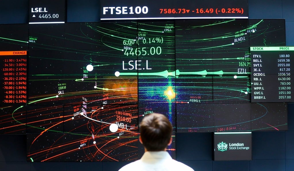 An employee looks at FTSE 100 share price information in the atrium of the London Stock Exchange Group’s offices in London on July 6. Financial analysts and the independently wealthy are among those prospering in the present economy. Photo: Bloomberg