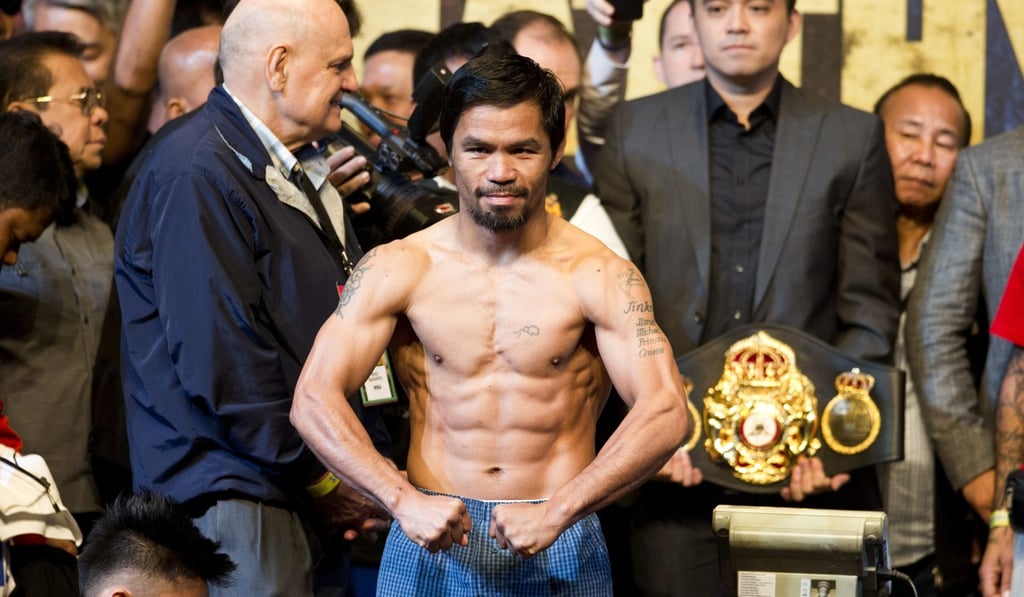 Manny Pacquiao poses after weigh-in in Kuala Lumpur. Photo: AP