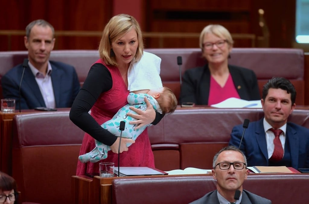 Australian Senator Larissa Waters of the Greens Party breastfeeds her daughter Alia Joy as she speaks. Photo: Reuters