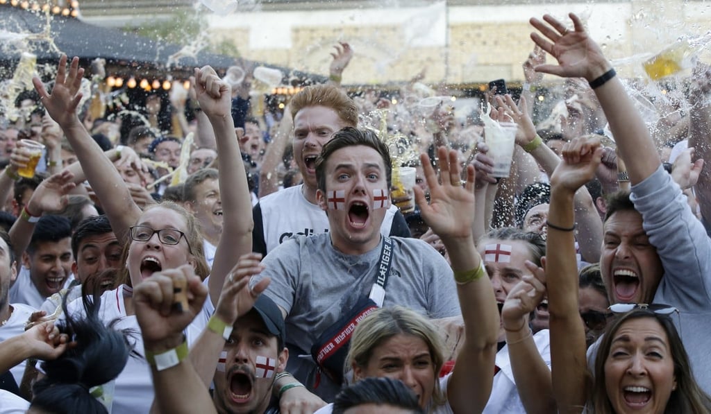 England fans celebrate England's opening goal against Croatia. Photo: AP