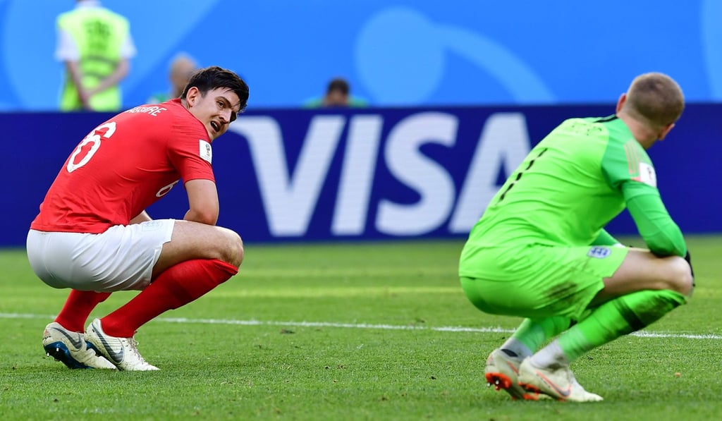 England’s Harry Maguire commiserates with teammate Jordan Pickford. Photo: AFP
