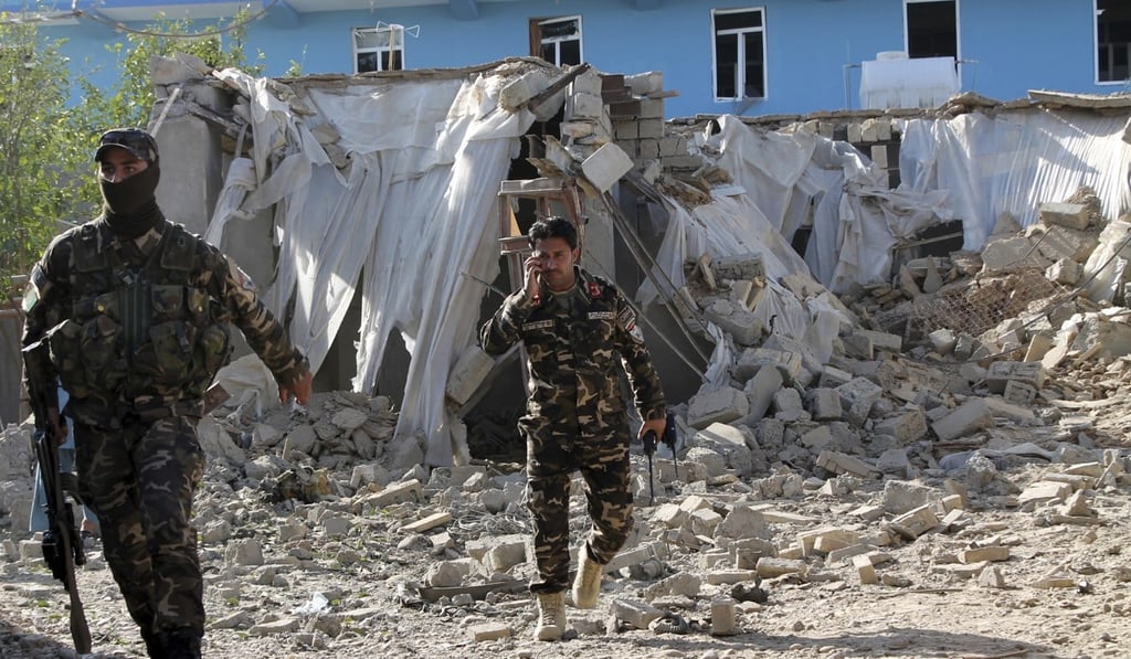 Soldiers inspect an explosion site in Lashkar Gah, capital of southern Helmand province, Afghanistan on February 24, 2018. Photo: AP