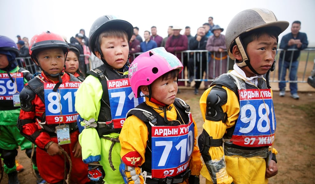 Child jockeys wait in line for a check-up before a horse race at the Naadam festival. Photo: Reuters