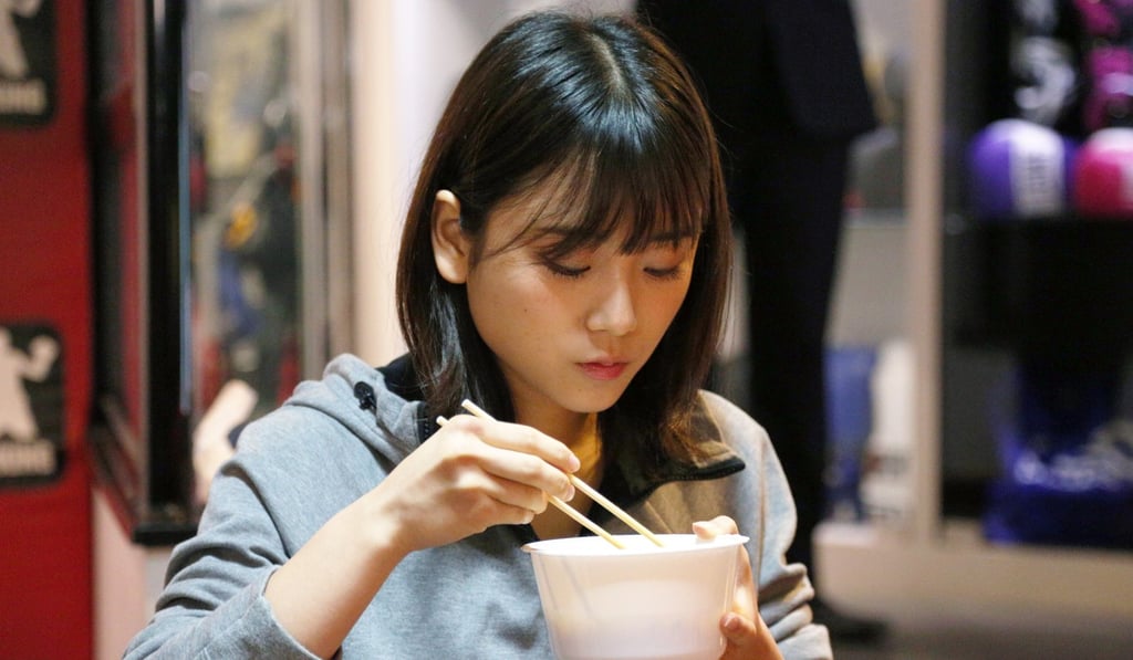 Suzuki eats some local Hong Kong noodles immediately after weighing in.