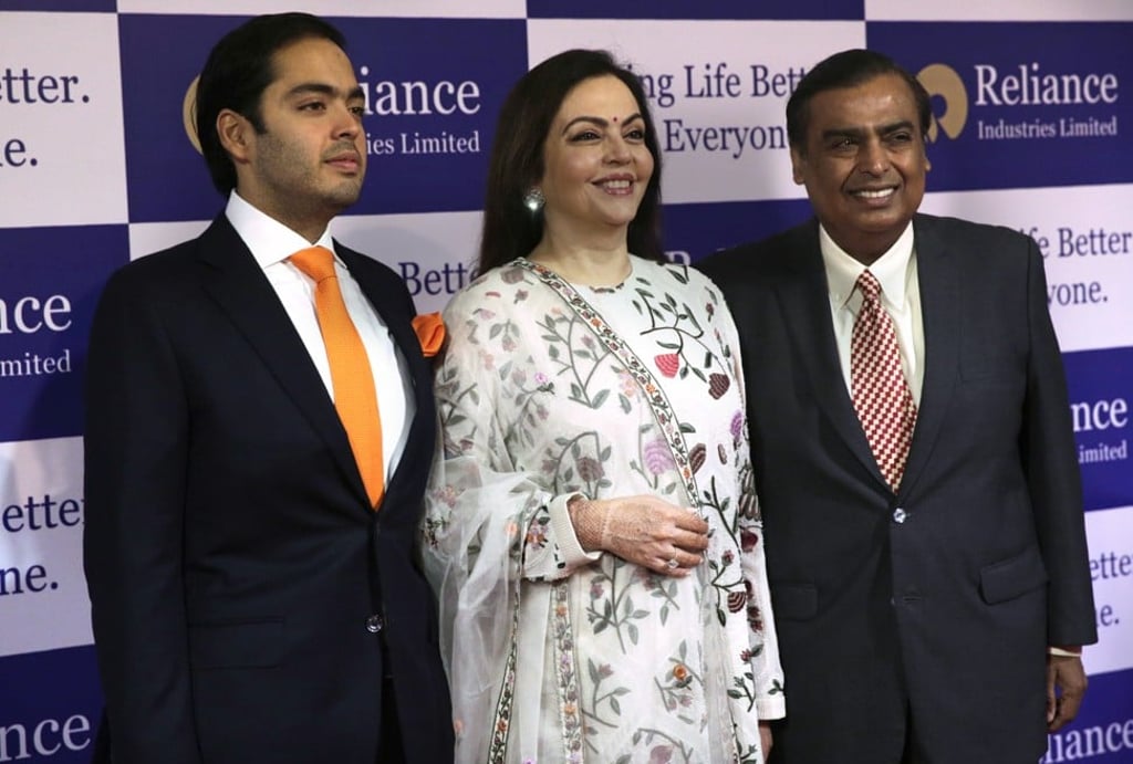 Mukesh Ambani (right), his wife Nita Ambani, and son Anant Ambani before Reliance Industries’ annual meeting in Mumbai, India on Thursday, July 5. Reliance is India's largest private sector company. Photo: Rafiq Maqbool/ AP
