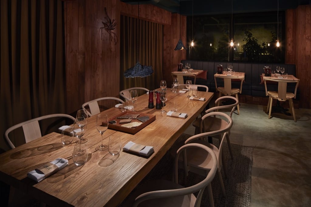 The Flying Elk’s wooden interiors set the tone of a Scandinavian hunting cabin in Hong Kong’s Wyndham Street.