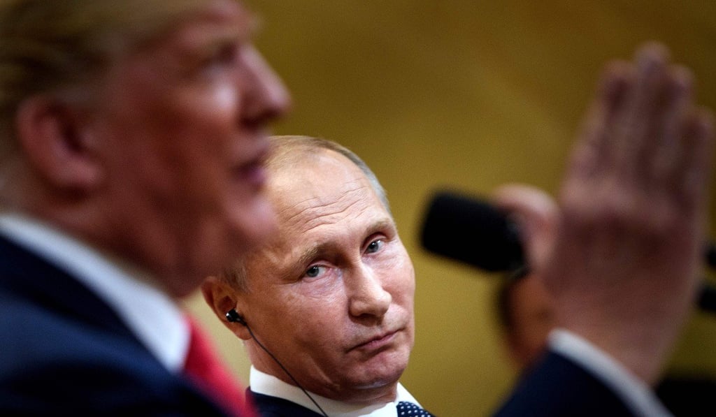 Russia's President Vladimir Putin listens while US President Donald Trump speaks during a press conference at Finland's Presidential Palace in Helsinki on Monday. Photo: AFP