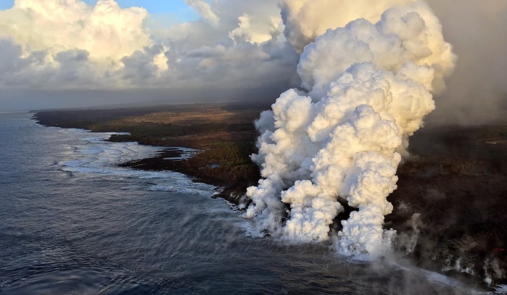 This handout photograph obtained July 16, courtesy of the US Geological Survey, shows plumes rising where lava pours into the sea on the south margin of the fissure 8 flow of the Kilauea volcano on Sunday. Photo: Agence France-Presse This handout photograph obtained July 16, courtesy of the US Geological Survey, shows plumes rising where lava pours into the sea on the south margin of the fissure 8 flow of the Kilauea volcano on Sunday. Photo: Agence France-Presse
