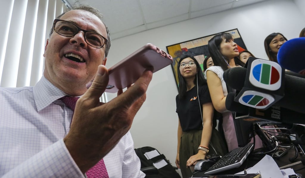 After the top court’s ruling, QT, whose identity was not made public, answers media questions on the phone of her lawyer Michael Vidler (left), during a press conference on July 4. Photo: Dickson Lee