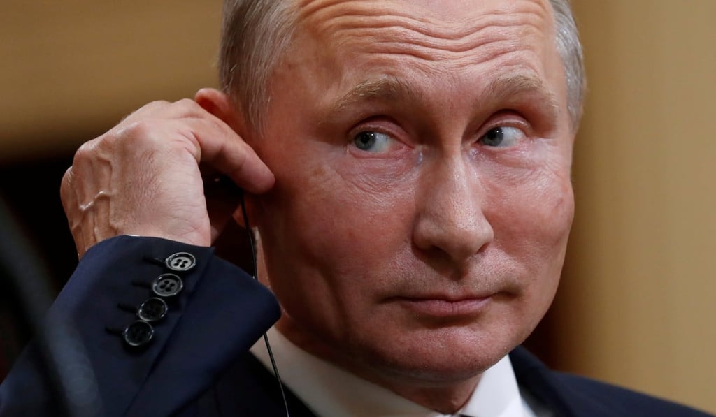 Russian President Vladimir Putin listens as US President Donald Trump speaks during their news conference in Helsinki. Photo: Reuters
