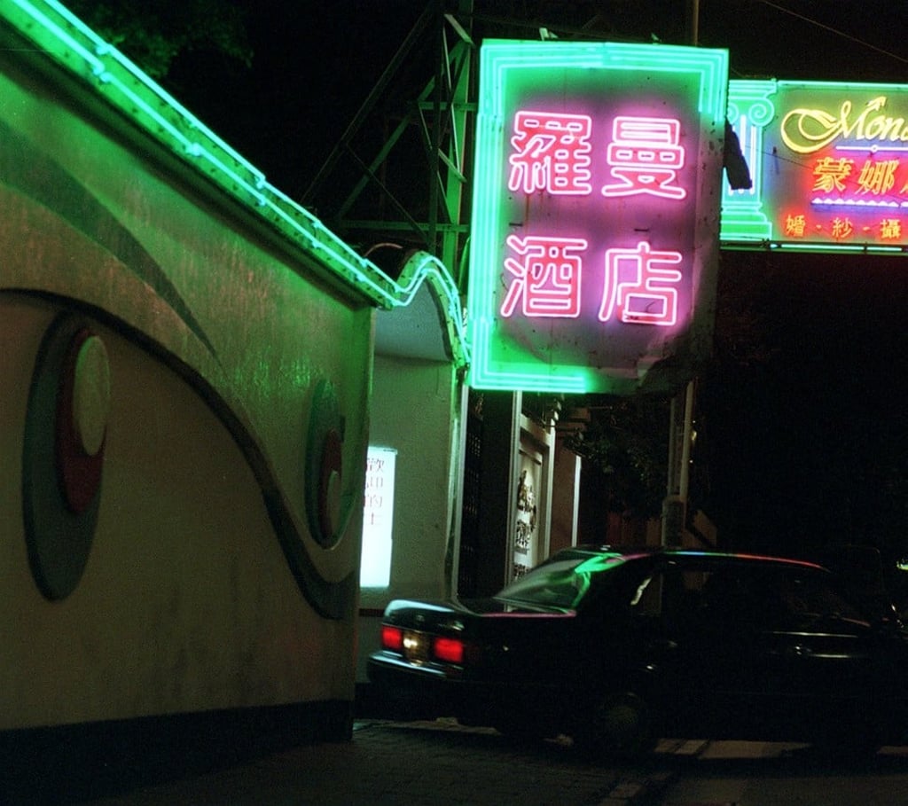 A neon sign shines outside the Romantic Hotel occupying the house where Lee lived in Kowloon Tong. Photo: Antony Dickson