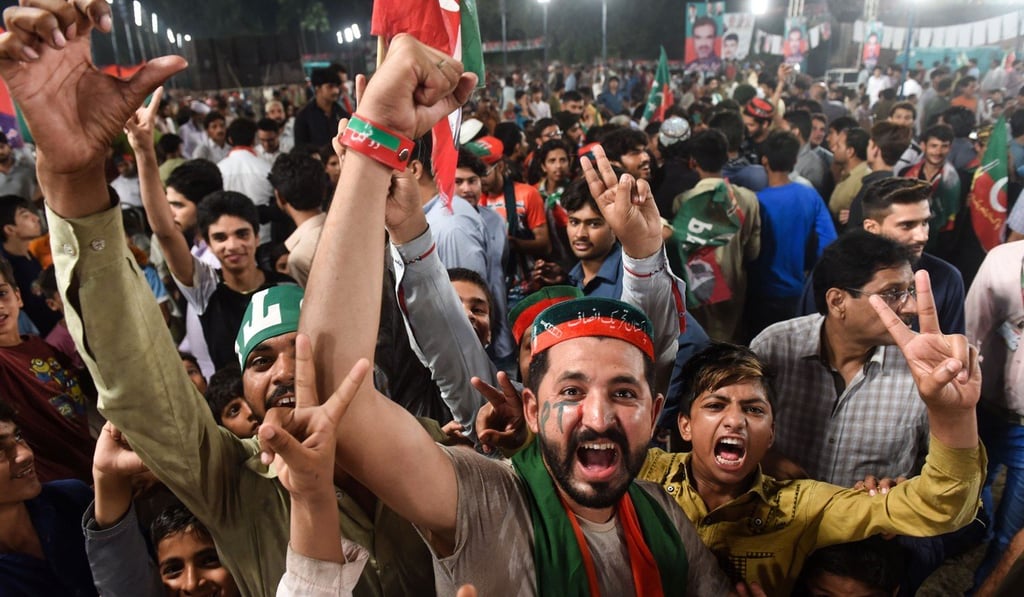 Supporters of Pakistani cricket star-turned-politician and head of the Pakistan Tehreek-e-Insaf Imran Khan gather in Lahore at his campaign rally for the upcoming general election. Photo: AFP