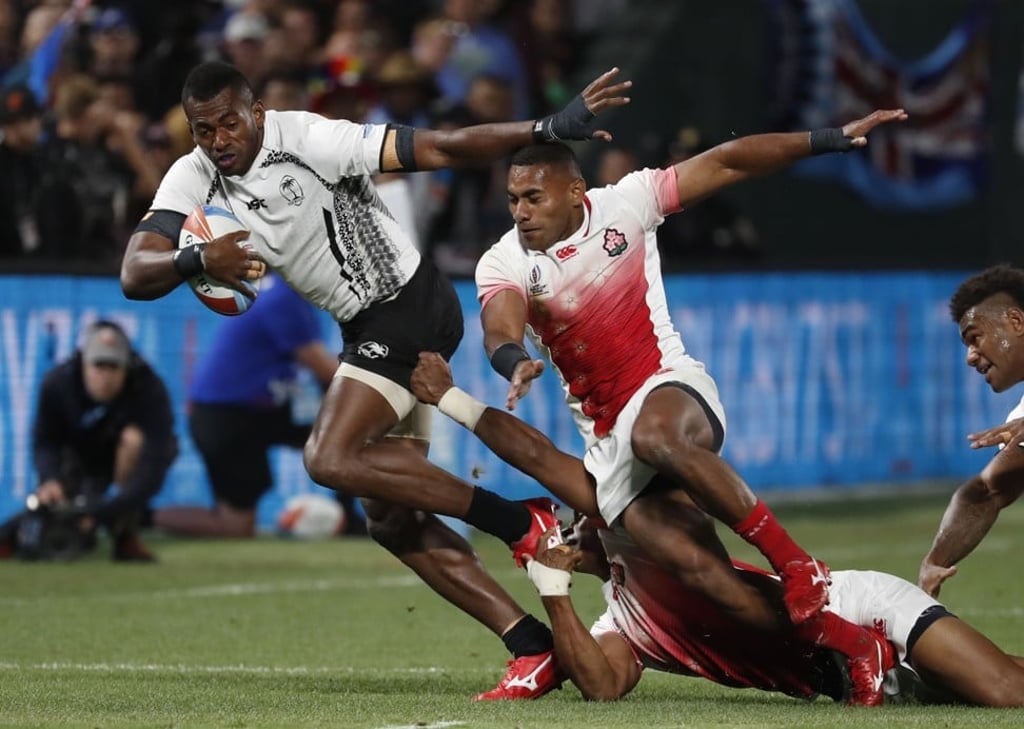 Fiji’s Sevuloni Mocenacagi looks to evade the Japan defence. Photo: EPA