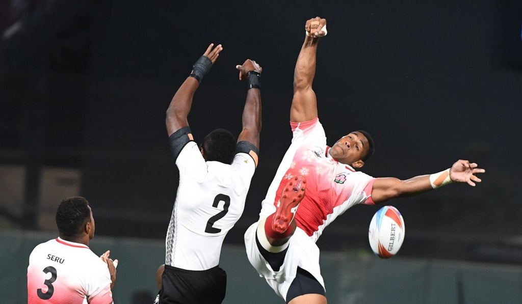 Sevuloni Mocenacagi of Fiji clashes with Jose Coyickai Seru (left) and Jone Naikabula (right) of Japan. Photo: AFP