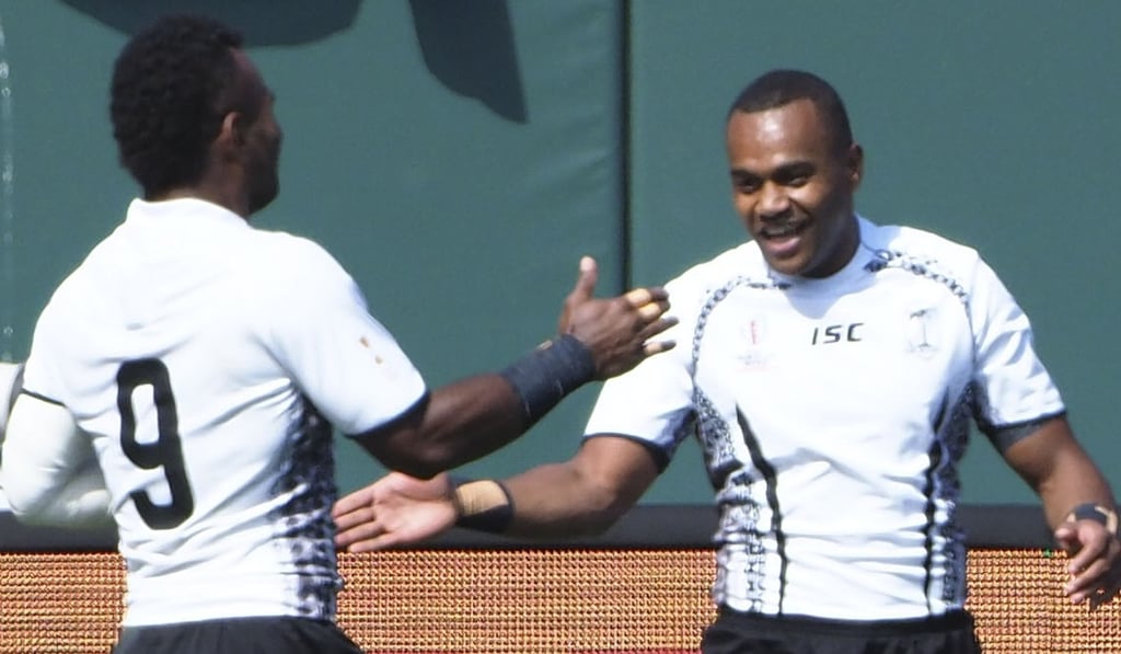 Alosio Naduva (right) is congratulated by Jerry Tuwai after scoring against Argentina. Photo: USA Today Sports