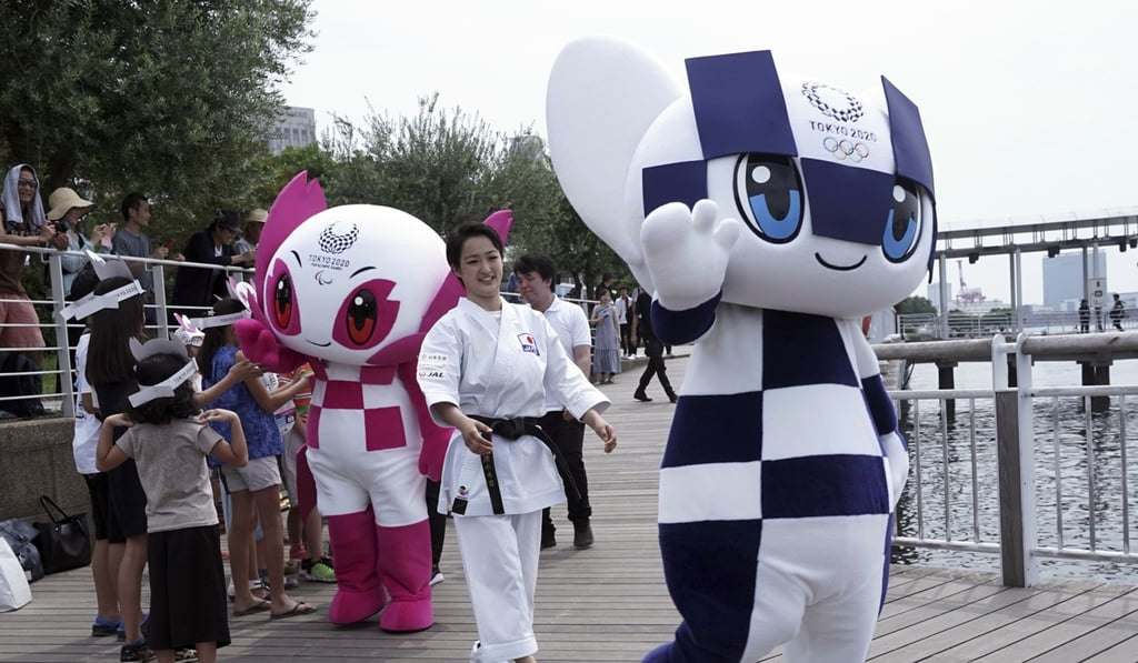 Miraitowa and Someity walk on the pier after their water parade with Tokyo’s landmark ‘Rainbow Bridge’ in the background. Photo: AP Miraitowa and Someity walk on the pier after their water parade with Tokyo’s landmark ‘Rainbow Bridge’ in the background. Photo: AP