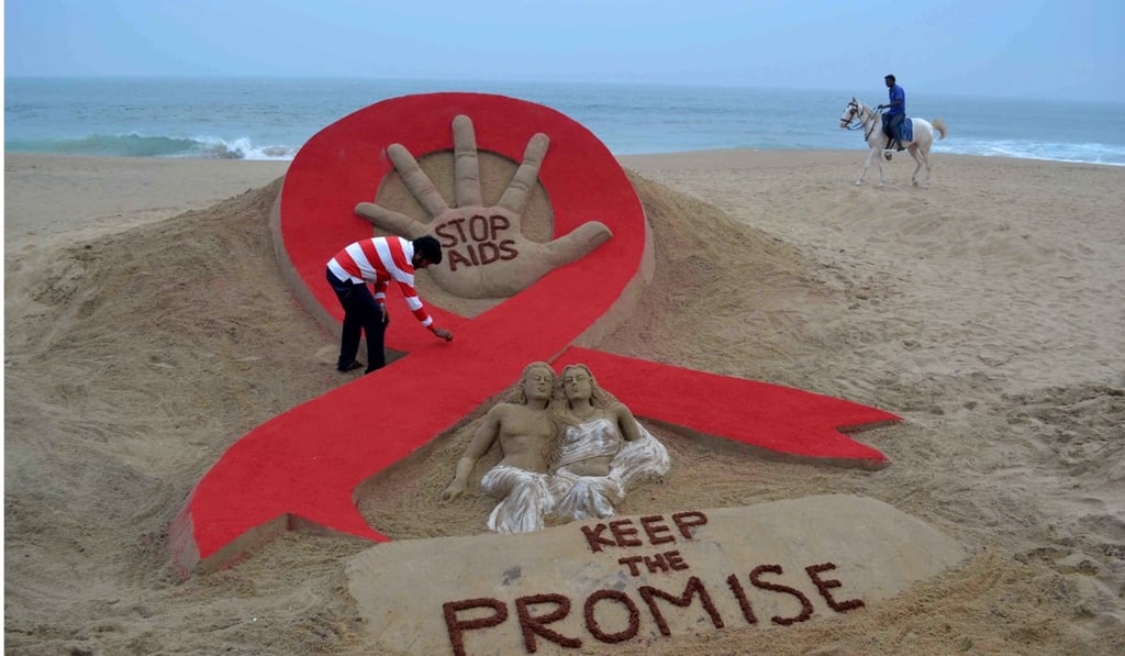 Indian sand artist Sudersan Pattnaik gives the final touches to a sand sculpture as a horseman rides by on Golden Sea Beach in Puri, some 65 kms east of Bhubaneswar, in this file photo. Photo: Agence France-Presse