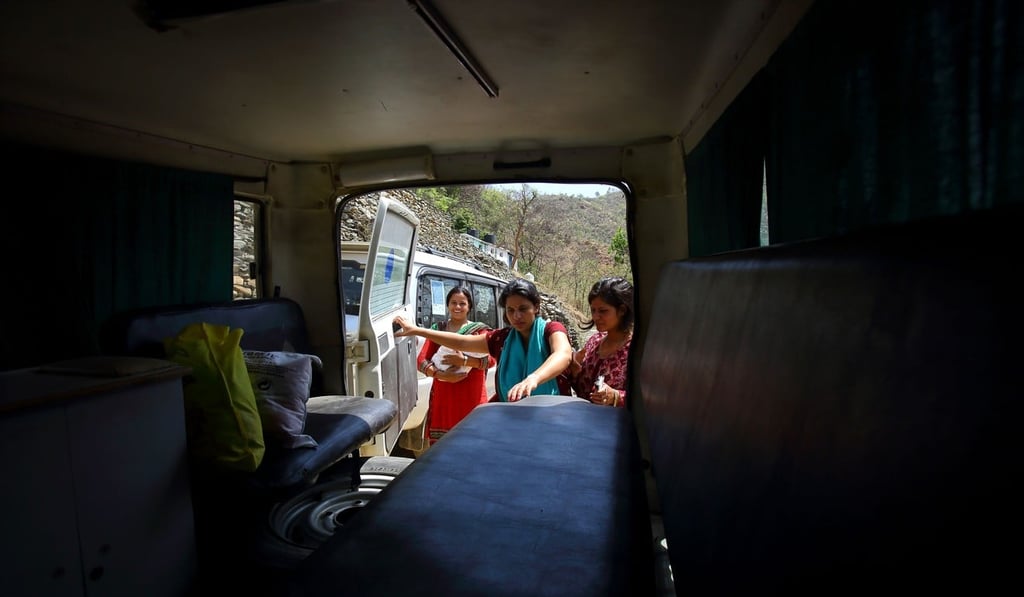 Nepali mother Pabitra Dhungel gets into an ambulance a day after giving birth. Photo: AFP Nepali mother Pabitra Dhungel gets into an ambulance a day after giving birth. Photo: AFP