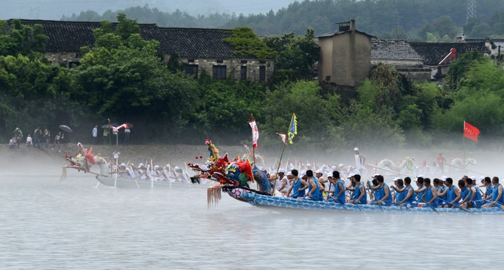 Competitors take part in the Dragon Boat Festival in Jingxian County, China. Photo: Xinhua