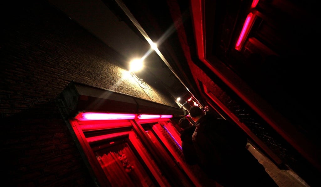 Customers walk around the red-light-district windows in the “wallen” red-light district of Amsterdam in this file photo. Photo: Agence France-Presse