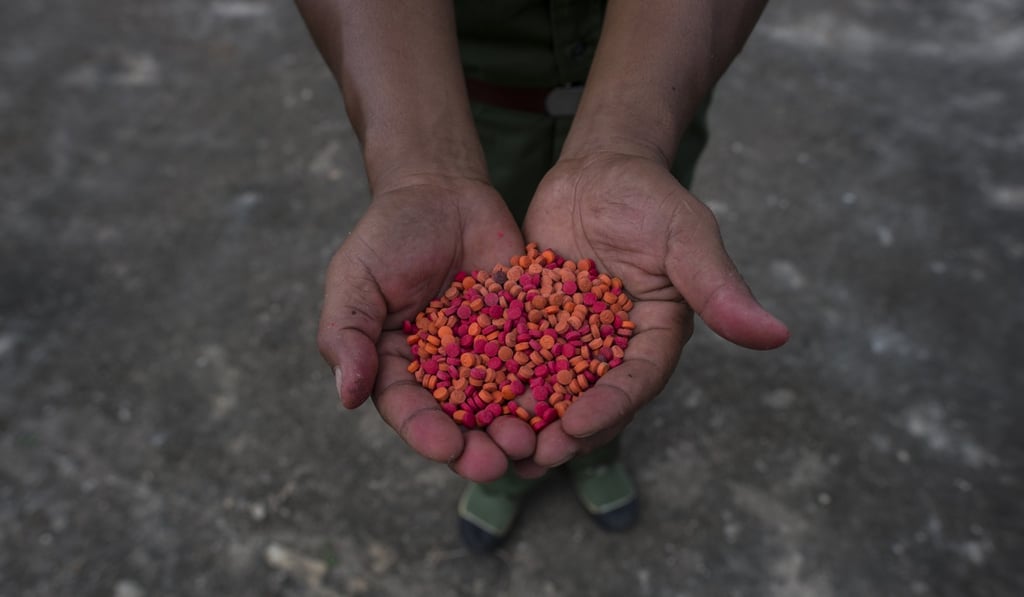 A member of the United Wa State Army displays yaba pills before they are destroyed as part of a drug-burning ceremony to mark the United Nations’ world anti-drugs day in Poung Par Khem, near the Thai and Myanmar border, on June 26, 2017. Picture: AFP