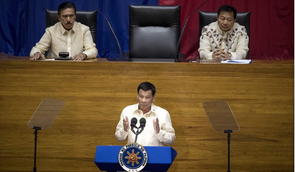 Duterte delivering his state-of-the-nation address, while Senate President Vicente Sotto (left) and House Speaker – at the time – Pantaleon Alvarez listen on July 23, 2018. Photo: AFP