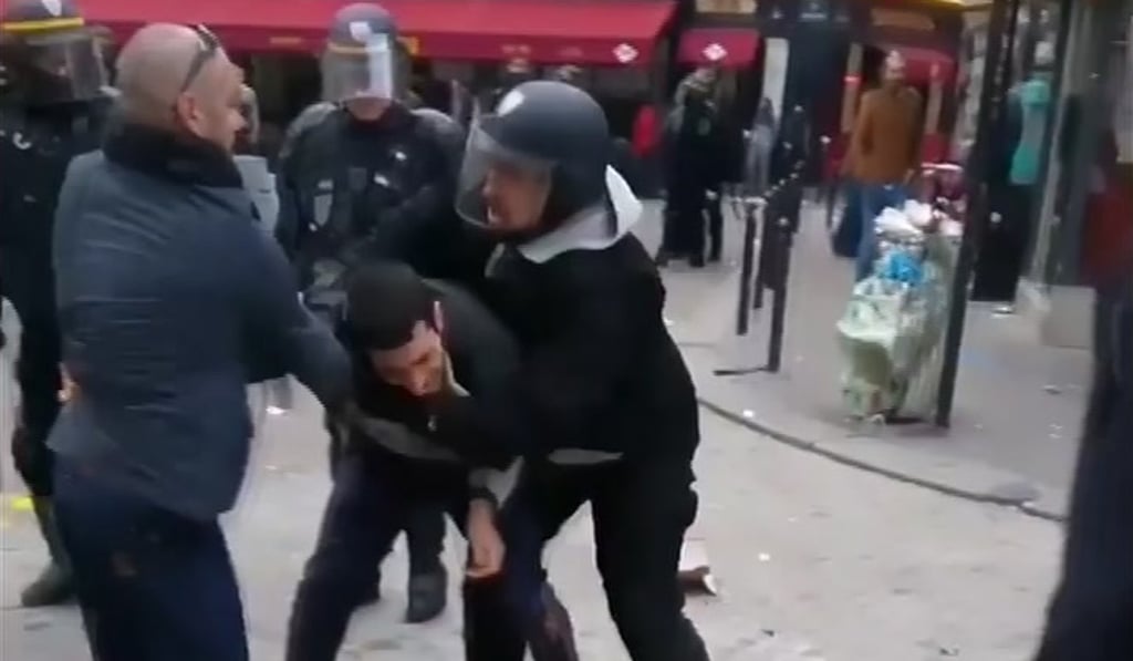 In this image taken from video, a man identified as Alexandre Benalla (right) a security chief to French President Emmanuel Macron, confronting a student during a May Day demonstration in Paris on May 1, 2018. Photo: Nicolas Lescaut via AP In this image taken from video, a man identified as Alexandre Benalla (right) a security chief to French President Emmanuel Macron, confronting a student during a May Day demonstration in Paris on May 1, 2018. Photo: Nicolas Lescaut via AP