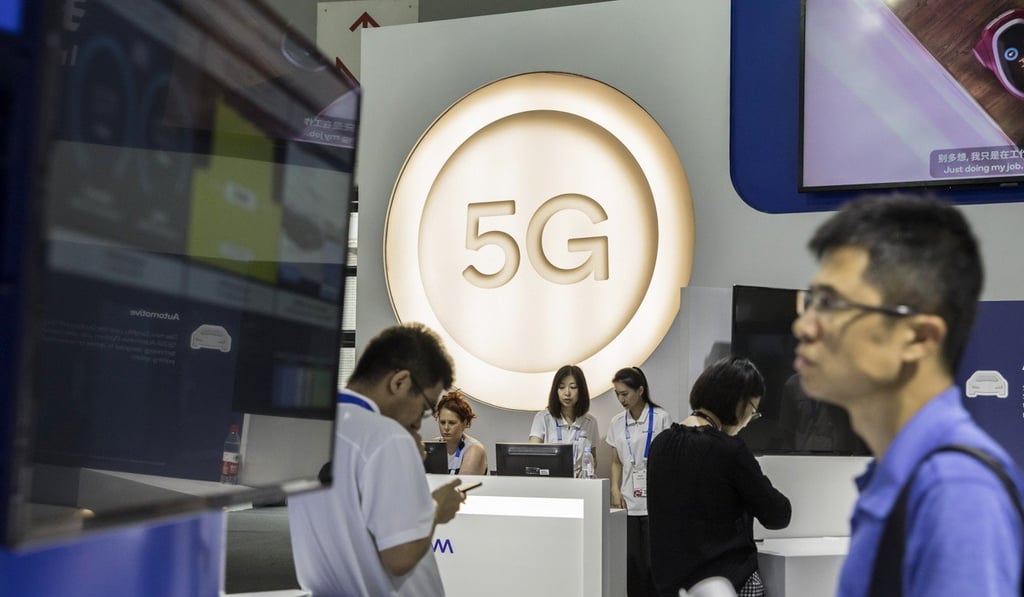 Attendees walk past a sign for 5G technology at the Qualcomm booth at the Mobile World Congress Shanghai on June 28. Photo: Bloomberg
