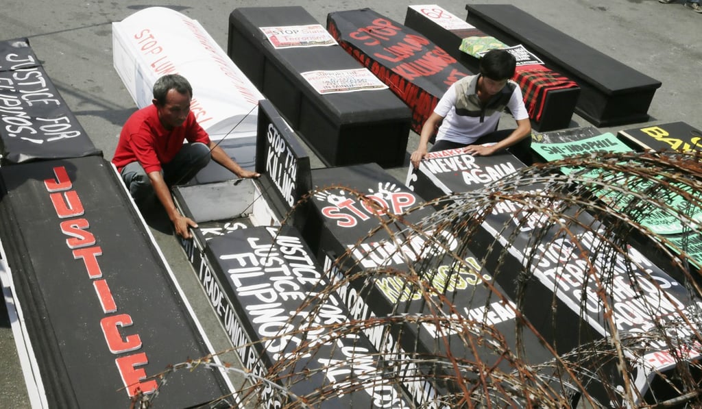 Protesters display several mock coffins representing victims of killings of activists. Photo: AP