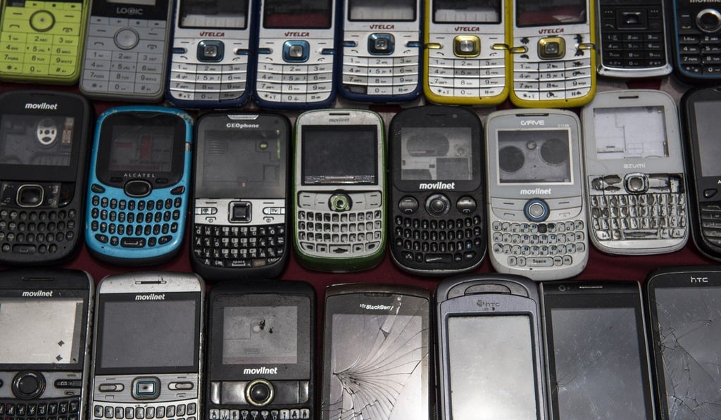 Second-hand mobile devices are displayed for sale at the stall of a street vendor in the Petare neighbourhood of Caracas. Photo: Bloomberg