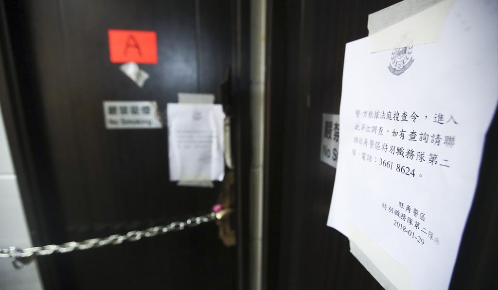 Police notices on a brothel door at the King Hing Building following raids in January. Photo: Edward Wong