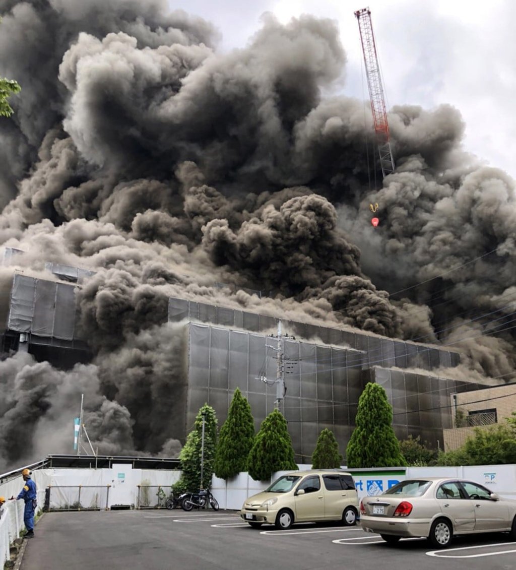 Black smoke billows from a construction site fire in Tama, suburban Tokyo, on Thursday. Photo: EPA