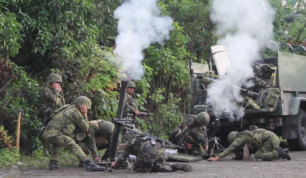 Soldiers from the Philippine Army’s 2nd Mechanised Infantry Division fire mortars at Bangsamoro Islamic Freedom Fighters. Photo: Reuters