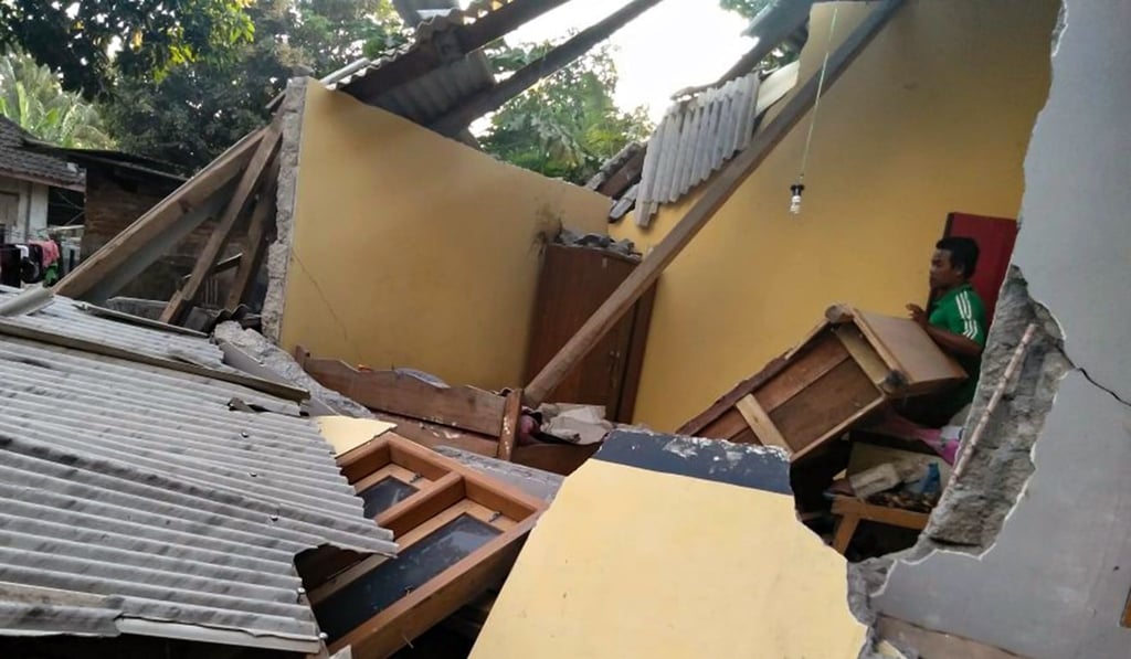 A man stands among the collapsed ruins of a house following the earthquake in Lombok. Photo: AFP A man stands among the collapsed ruins of a house following the earthquake in Lombok. Photo: AFP