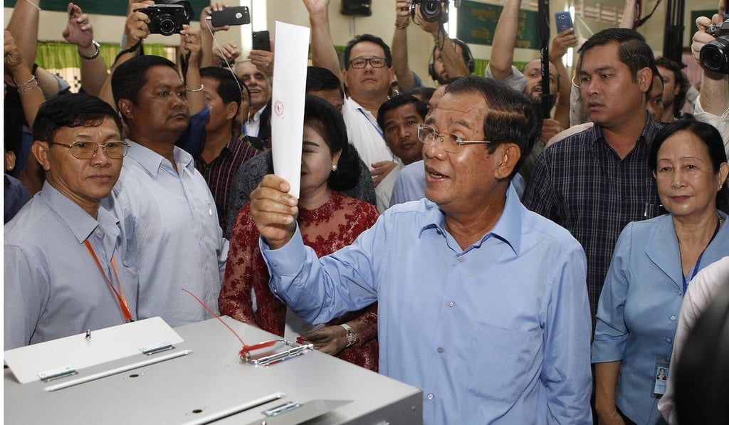 Cambodian Prime Minister Hun Sen looks at his ballot at a polling station in Takhmua, Kandal province on Sunday, July 29, 2018. Photo: AP