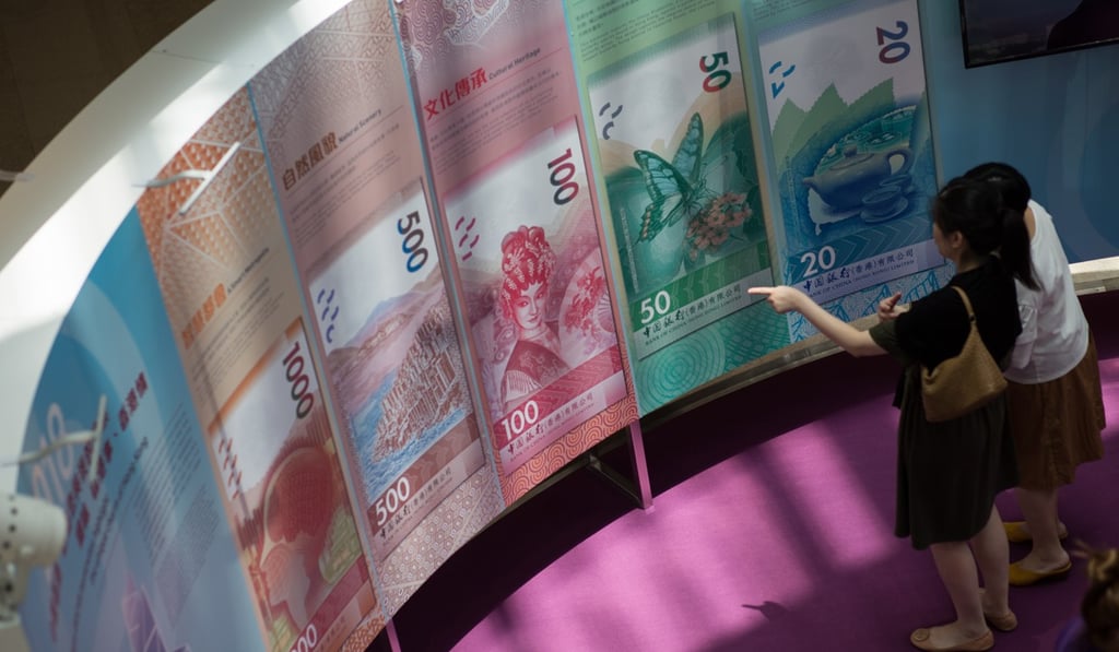 Visitors looking at poster samples of the new Hong Kong dollar banknotes. Photo: EPA-EFE