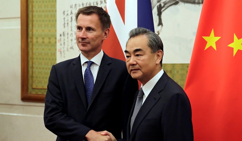 British Foreign Secretary Jeremy Hunt (left) shakes hands with Chinese Foreign Minister Wang Yi before their meeting at the Diaoyutai State Guesthouse in Beijing, China, on Monday. Photo: Pool via Reuters