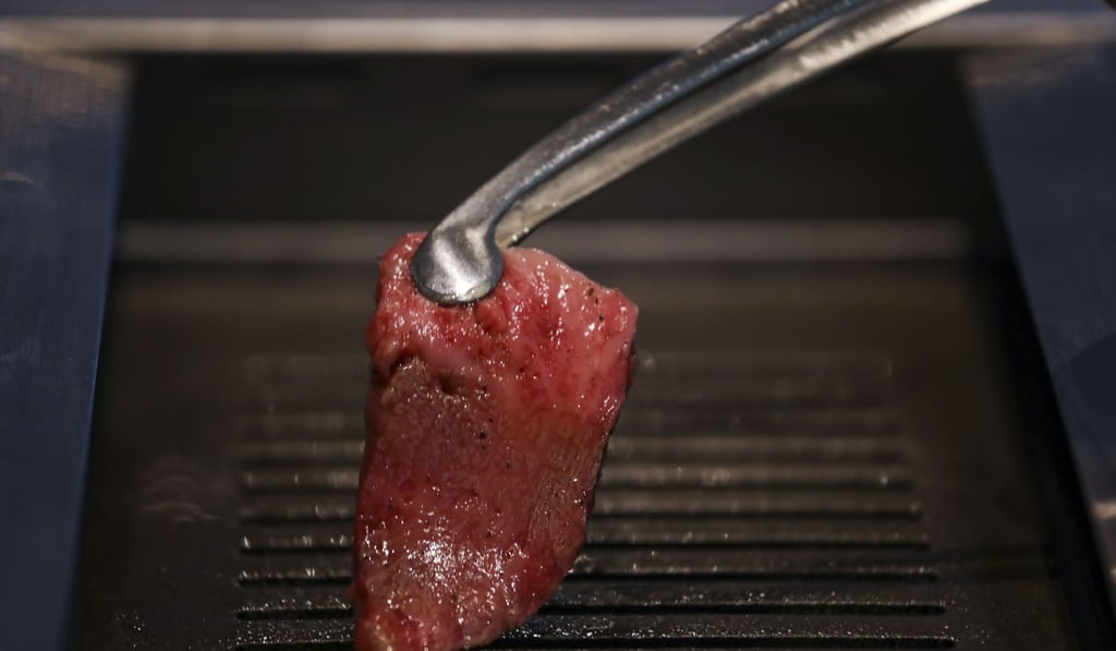 Grilling the beef at Yakiniku Jumbo in Central. Photo: Tory Ho