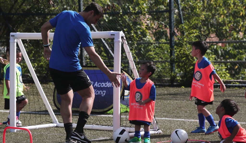 Javier Zanetti meets a new friend at a training session. Photo: Jonathan Wong