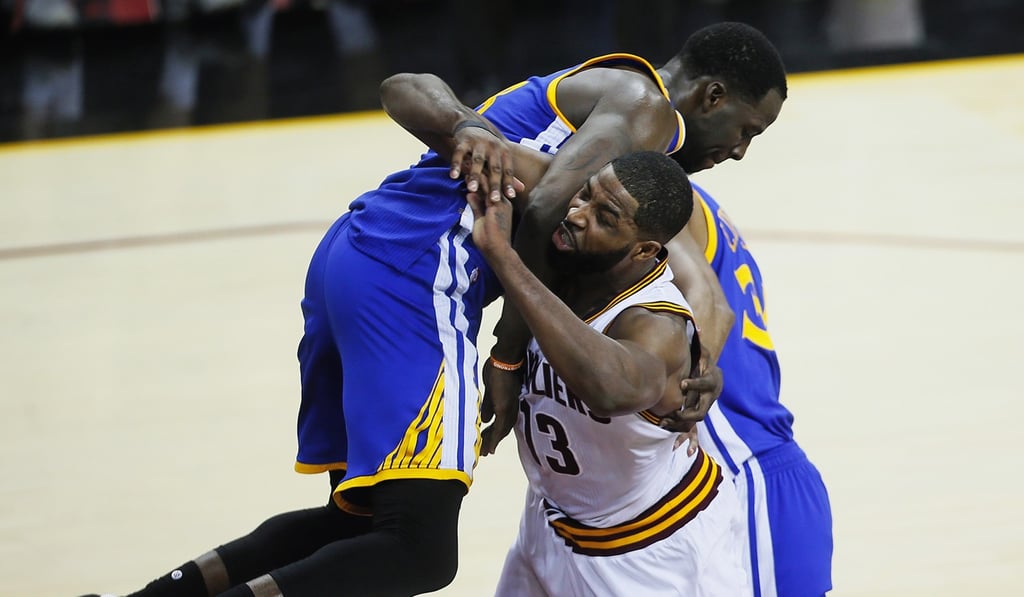 Draymond Green lands on Tristan Thompson in the fourth quarter during game four of the NBA Finals. Photo: TNS