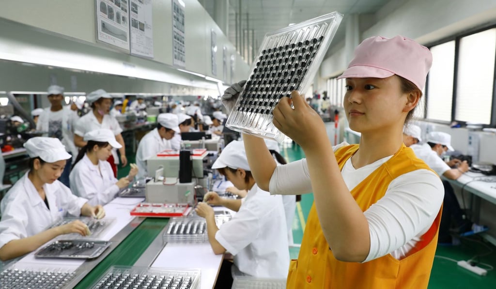 China’s economic growth is still on track, its top leaders said on Tuesday. Pictured is a micro motor production line. Photo: AFP China’s economic growth is still on track, its top leaders said on Tuesday. Pictured is a micro motor production line. Photo: AFP