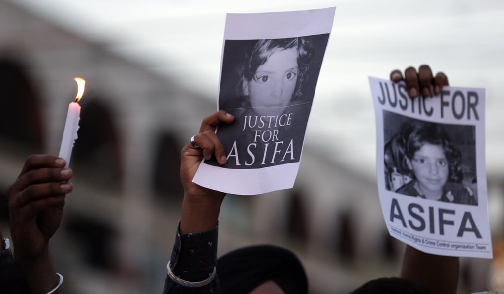 Protesters in Amritsar, India. hold up photos of the eight-year-old girl who was raped in the Indian state of Jammu and Kashmir, at a rally on April 15. Photo: EPA-EFE