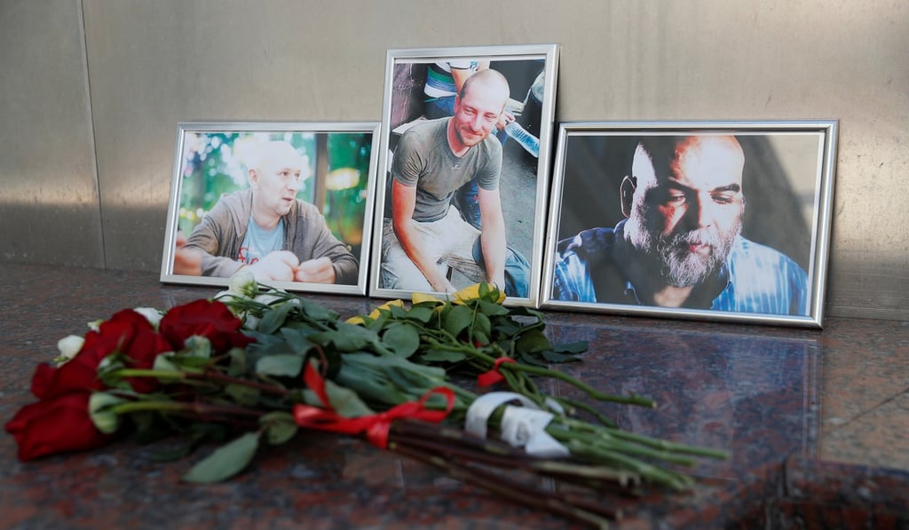 Photographs of journalists, (right to left) Orhan Dzhemal, Kirill Radchenko and Alexander Rastorguyev, who were recently killed in Central African Republic by unidentified assailants, are on display outside the Central House of Journalists in Moscow on Wednesday. Photo: Reuters