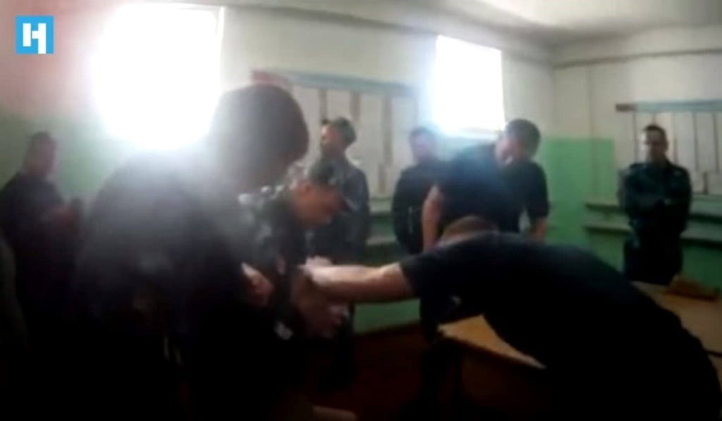 In this still from a video published by the Russian independent newspaper Novaya Gazeta, a prisoner is held by guards during a beating at a prison in Yaroslavl. Photo: YouTube / Novaya Gazeta In this still from a video published by the Russian independent newspaper Novaya Gazeta, a prisoner is held by guards during a beating at a prison in Yaroslavl. Photo: YouTube / Novaya Gazeta