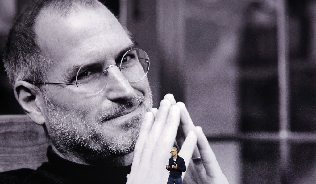 A photograph of Steve Jobs projected in the background dwarfs Apple’s CEO Tim Cook during a new product announcement in 2017. Photo: AP