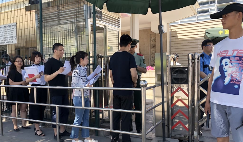 Visa applicants line up for interviews outside the American embassy in Beijing on May 30. Photo: Simon Song