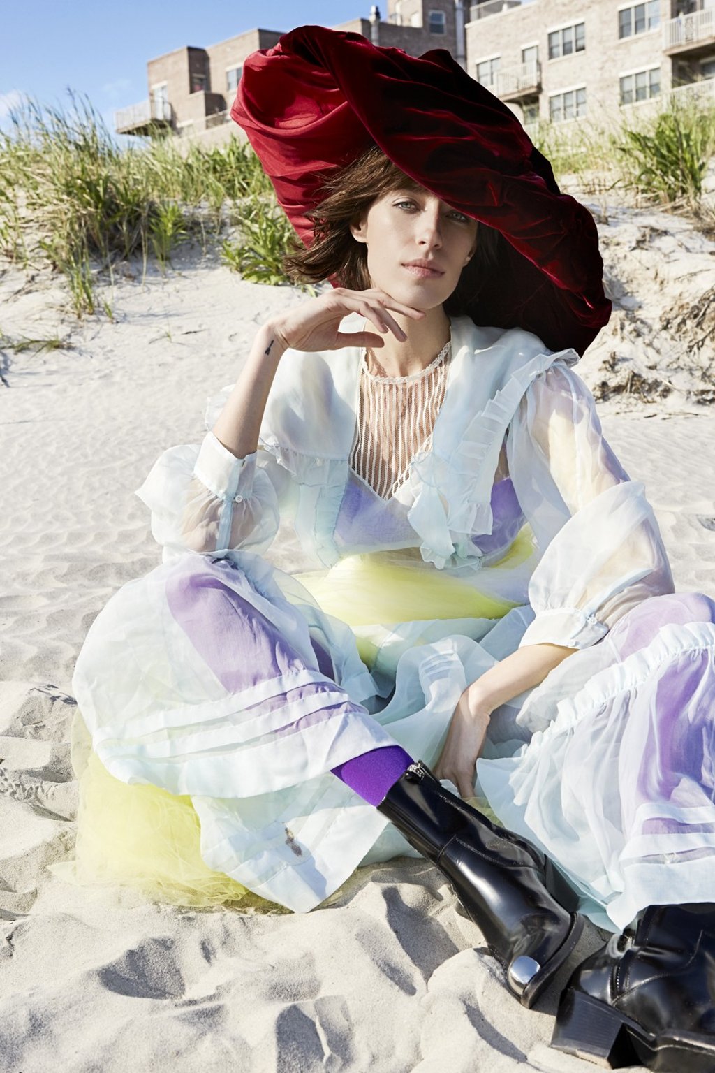 CALVIN KLEINRuffled silk organza dress. Price on requestPioneer dress in light blue. Price on requestShort boots. Price on request EMILIO CAVALLINI Purple hosiery. Price on request HEATHER HUEYRed velvet and satin draped wide brim hat. Price on request